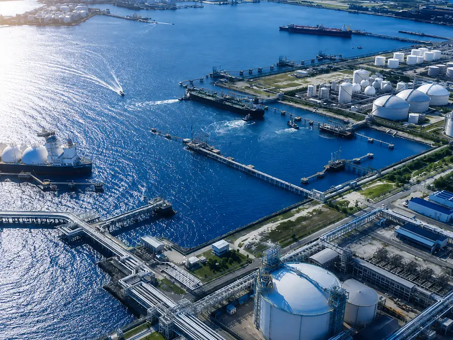 Aerial view of an LNG terminal, its tanker berths, jetties and storage tanks