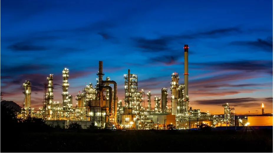 Petrochemical refinery illuminated at dusk