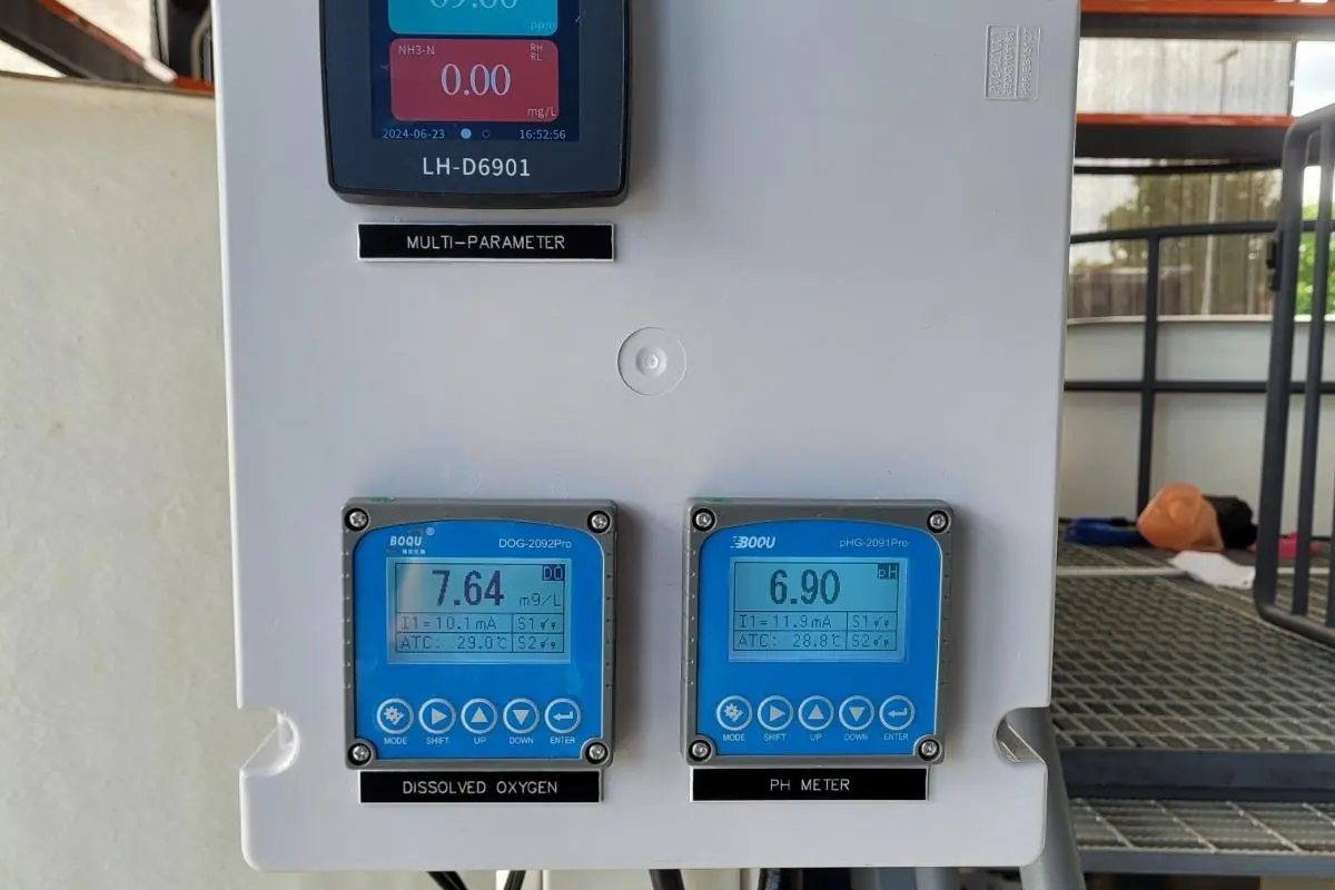 Water quality transmitters mounted at an aquaculture tank, displaying live readings